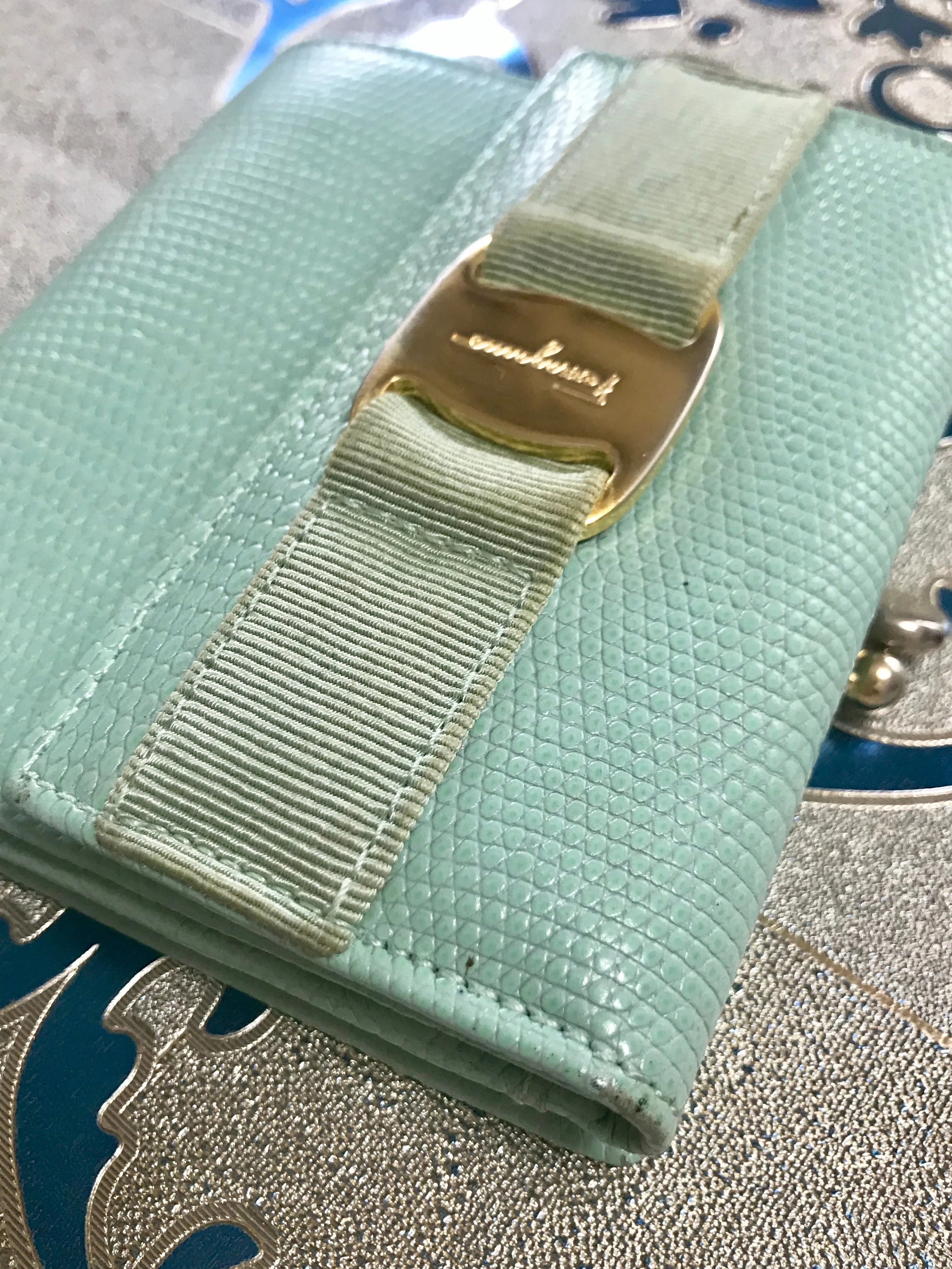 Vintage Salvatore Ferragamo blue lizard embossed leather wallet with gold tone vara motif. 05063012